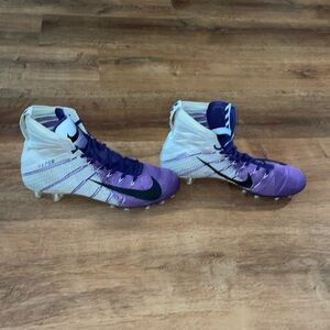 Purple high top Nike football cleats
